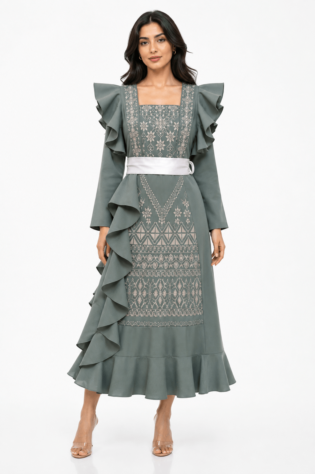 Dalaa Modern Palestinian Dress model wearing a modern embroidered Thoub with ruffles and a stylish belt.