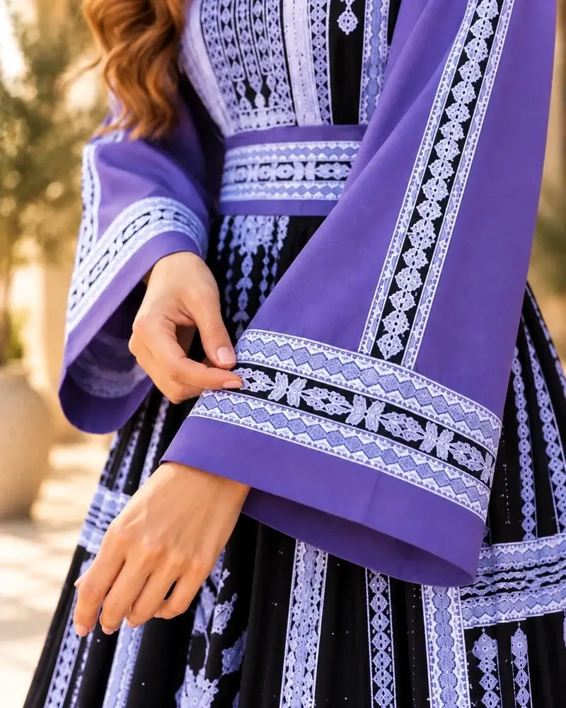 Close-up of the Elegant Embroidered Dress showcasing intricate embroidery details and elegant sleeves.