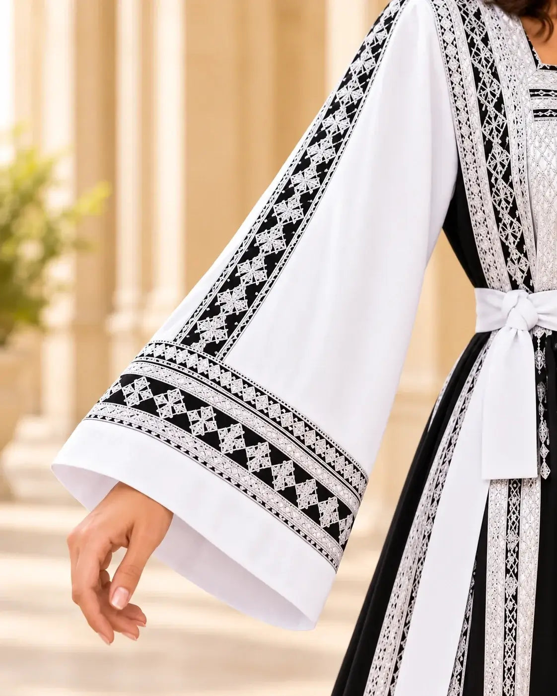 Elegant Embroidered Dress showcasing intricate black and white embroidery on a flowing sleeve design.