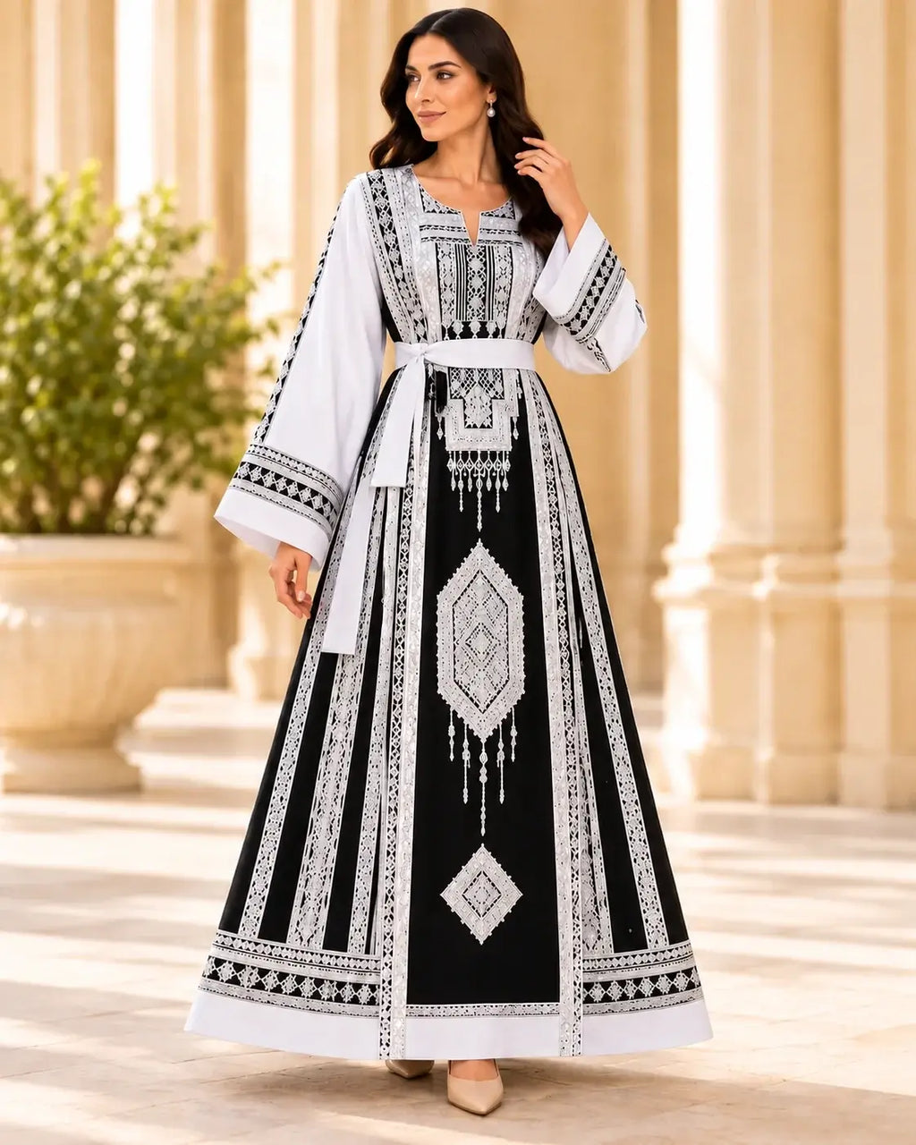 Elegant Embroidered Dress modeled by a woman, showcasing intricate Jordanian-inspired embroidery on a modern silhouette.